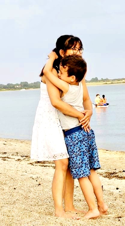 Chrisma hugging Matthias on the beach – a moment of love and strength.